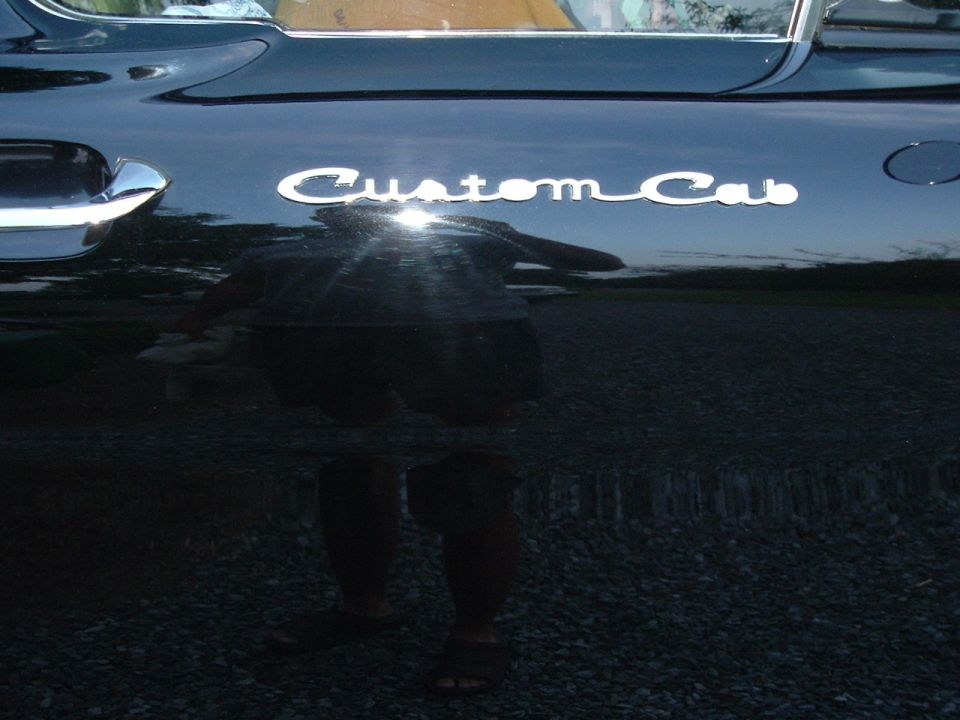 1966 Ford F-100 Custom Cab door emblem on black paint