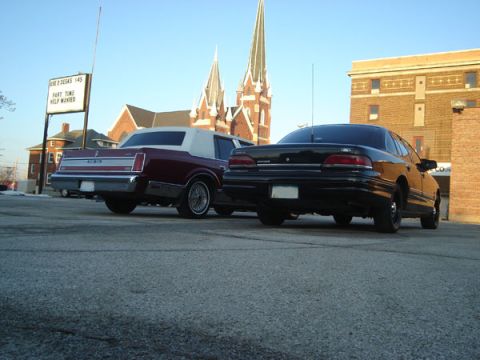 1992 Ford Crown Victoria - Rear view of a black 1992 Ford Crown Victoria parked next to a maroon sedan.