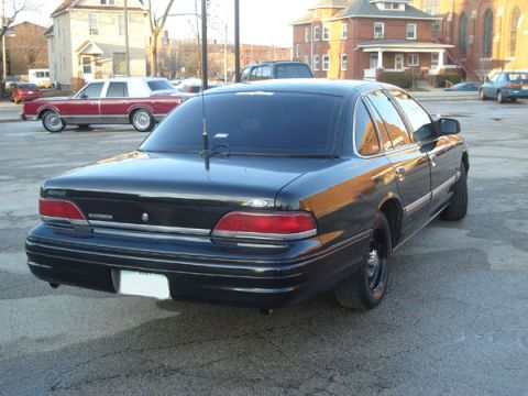 1992 Ford Crown Victoria - Rear view of a black 1992 Ford Crown Victoria parked on asphalt.
