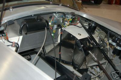 1965 Shelby Cobra - The engine bay of a 1965 Shelby Cobra, revealing its intricate wiring and mechanical components.