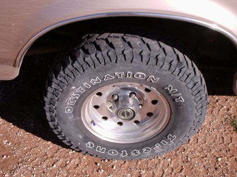 1996 Ford Bronco - A close-up view of a vehicle's wheel and tire, showing the "Firestone Destination M/T" branding.