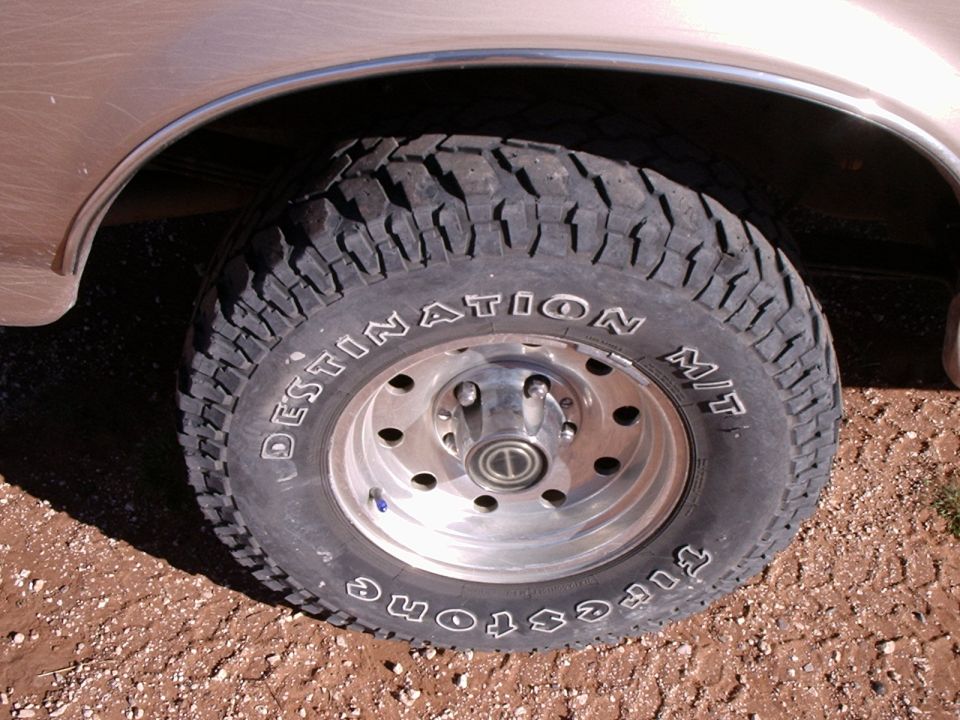 Close-up of a Firestone Destination M/T tire on a vehicle's wheel