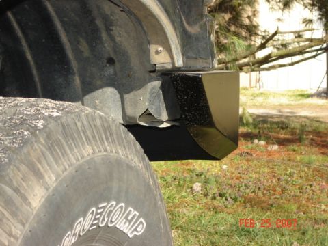 1990 Ford Bronco - Close-up of the rear bumper corner and tire of a 1990 Ford Bronco.