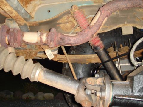 1996 Ford Bronco - Underside view of vehicle's driveshaft, U-joint, and exhaust system components.