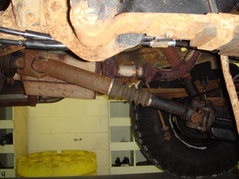 1996 Ford Bronco - Undercarriage view of a vehicle's driveshaft and suspension system, showing significant rust.