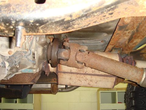 1996 Ford Bronco - Underside view of a vehicle's driveshaft and transmission, showing significant rust.