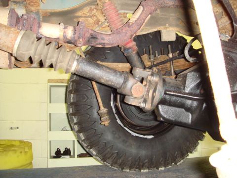 1996 Ford Bronco - Undercarriage view showing the driveshaft, U-joint, and rear axle assembly of a vehicle.