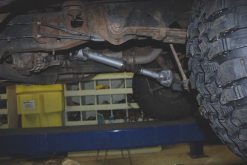 1996 Ford Bronco - Undercarriage view of a vehicle's driveshaft and suspension system, with visible rust.