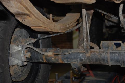 1996 Ford Bronco - Close-up view of a vehicle's rear axle and leaf springs, highlighting the components and their condition.