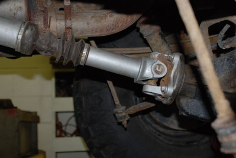 1996 Ford Bronco - Underside view of a vehicle's driveshaft and universal joint assembly.
