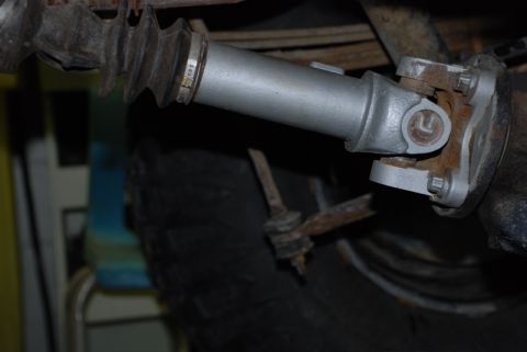 1996 Ford Bronco - Underside view of a vehicle's driveshaft and U-joint assembly, showing wear and some painted components.