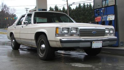 1991 Ford Crown Victoria LTD - This 1991 Ford Crown Victoria LTD is seen at a gas station, likely during a refueling stop.