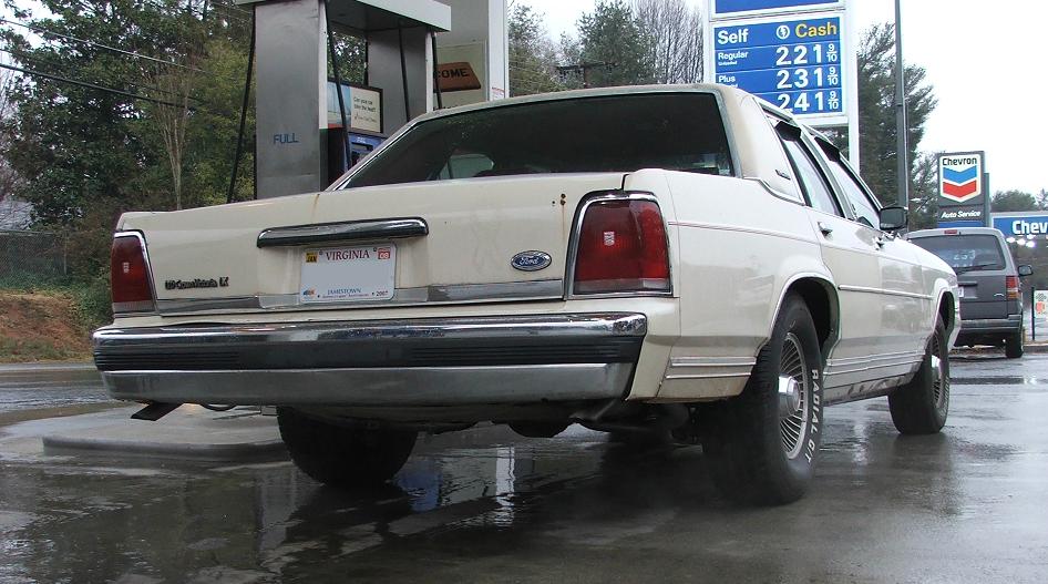 1991 Ford Crown Victoria LTD parked at a gas station, rear view. Virginia license plate visible