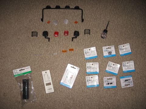 1990 Ford Bronco - Collection of RC car lighting parts including a light bar, lenses, and LED bulbs.
