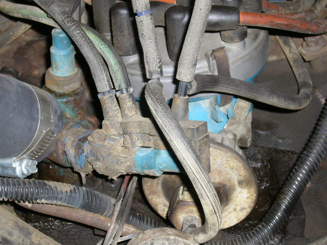 Close-up of engine parts with hoses and wires