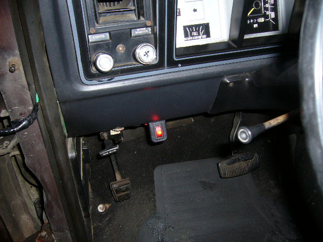 Dashboard interior of a 1979 Ford Bronco with pedals, switches, and gauges visible