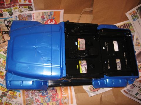 1990 Ford Bronco - Vehicle body parts, possibly from a Ford Bronco, are laid out on newspapers.