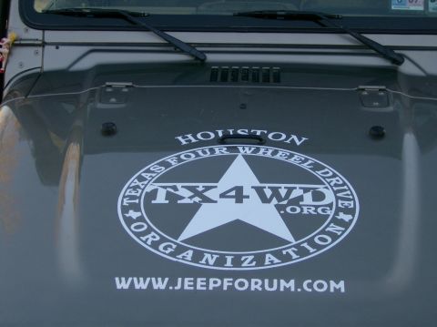 2004 Jeep Wrangler - The hood of a Jeep features a large decal for the Texas Four Wheel Drive Organization and the website jeepforum.com.