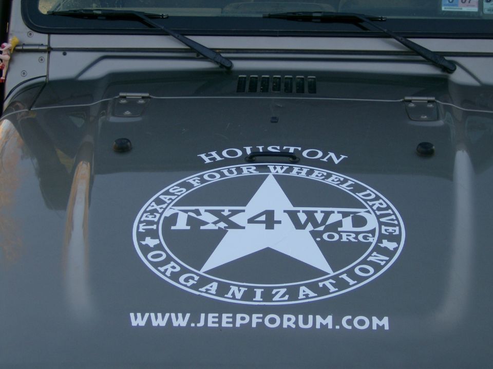 Gray Jeep hood with TX4WD Organization decal and jeepforum.com website