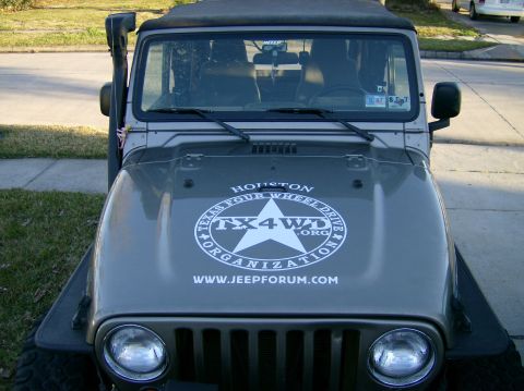2004 Jeep Wrangler - This Jeep Wrangler features a prominent TX4WD Organization decal on its hood, along with a snorkel on the driver's side.