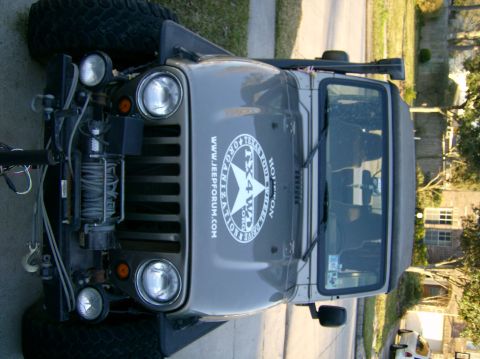 2004 Jeep Wrangler - This Jeep Wrangler features a winch mounted on the front bumper and a "TX 4WD" sticker on its hood.
