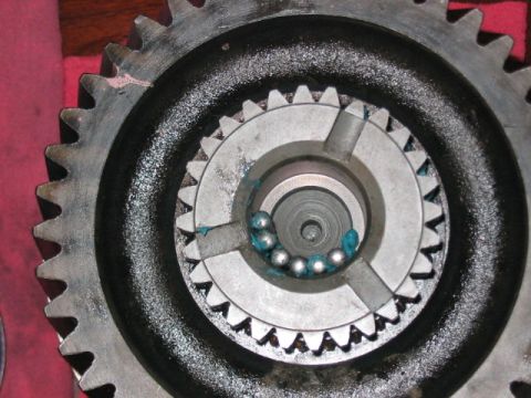 1991 Ford Bronco - Gears and ball bearings are visible, coated in blue grease, suggesting a mechanical component.