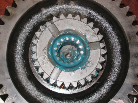 1991 Ford Bronco - Gears and bearings, likely from a transmission or differential, are covered in blue grease.