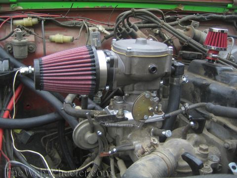 1987 Suzuki Samurai - Close-up view of a vehicle's engine bay, focusing on the carburetor and air intake system.