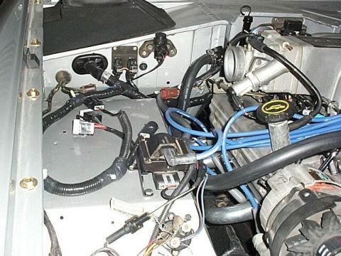 1986 Ford Bronco - Close-up view of the engine bay wiring harness, showing various connectors and components.