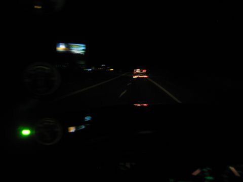 1996 Ford Bronco - Driving on the highway at night, with dashboard lights visible and other vehicles ahead.