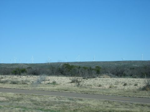 1996 Ford Bronco - A landscape scene numerous wind turbines spread across a rolling hill under a bright blue sky.