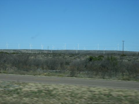 1996 Ford Bronco - A landscape scene with numerous wind turbines dotting the horizon under a bright blue sky.