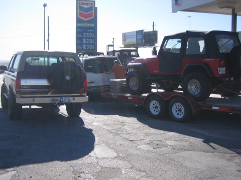 1996 Ford Bronco - A 1996 Ford Bronco is parked next to a trailer carrying a red Jeep Wrangler.