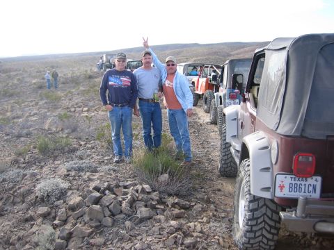 1996 Ford Bronco - A group of off-road enthusiasts pose with their vehicles lined up on a trail.