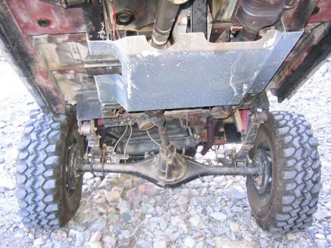 1987 Suzuki Samurai - The undercarriage of a 4x4 vehicle, showing its suspension and drivetrain components.