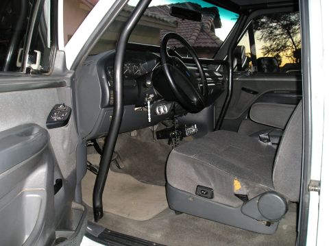 1993 Ford Bronco - Interior view of a 1993 Ford Bronco, highlighting the custom roll cage and driver's seat.
