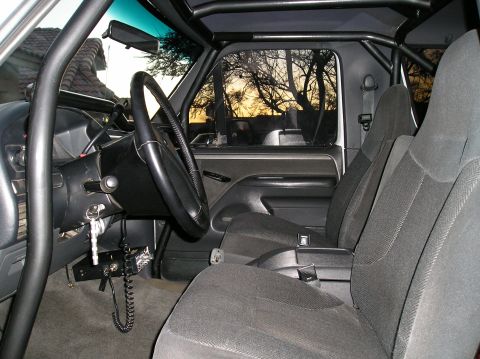 1993 Ford Bronco - Interior view of a 1993 Ford Bronco, equipped with a roll cage and CB radio.