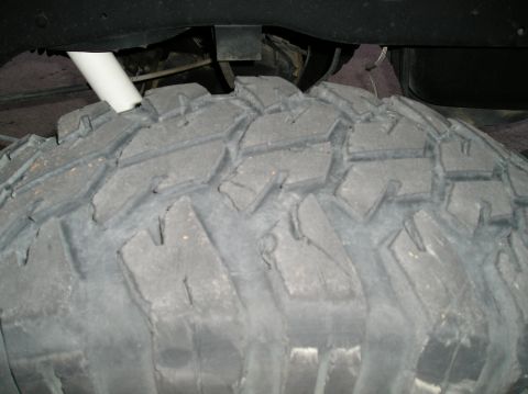1993 Ford Bronco - A close-up view of an off-road tire and suspension components, with a watermark for Supermotors.net visible.