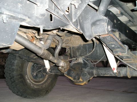1993 Ford Bronco - Undercarriage view reveals suspension and drivetrain parts of an unidentified vehicle.