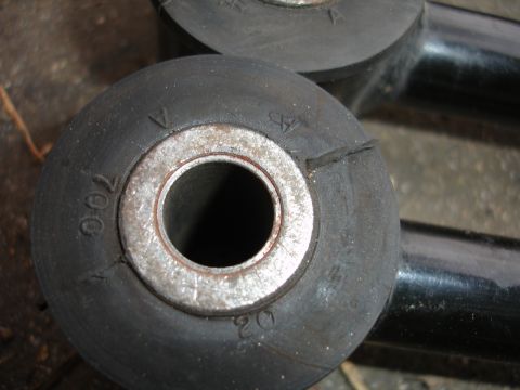 1992 Ford Taurus - Close-up of a rubber suspension bushing with visible markings and a metal center.