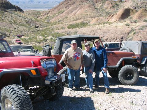 1996 Ford Bronco - A group of men pose with their Jeeps in a , mountainous landscape.