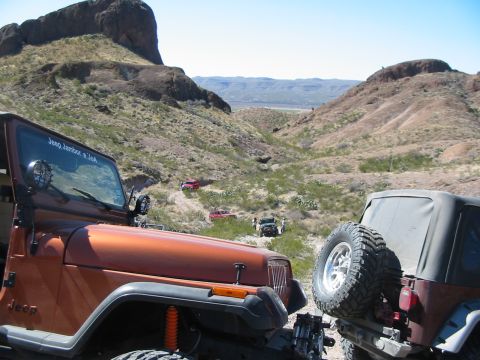 1996 Ford Bronco - Off-roading adventure with multiple Jeeps navigating a challenging desert terrain.
