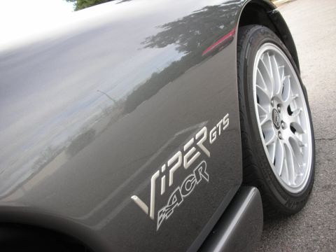 1998 Ford Crown Victoria - Detail of the chrome VIPER GTS ACR emblem on a gray fender, with a white split-spoke wheel and tire to the right.