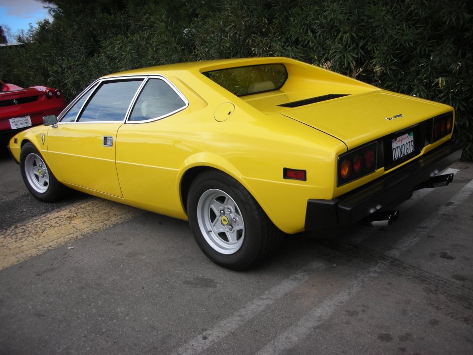 Yellow Ferrari Dino 308 GT4 coupe, rear three-quarter view