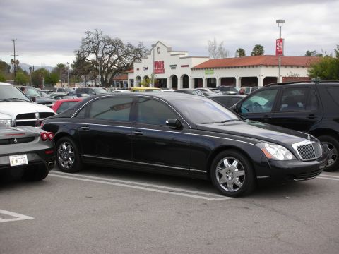 1998 Ford Crown Victoria - long black Maybach luxury sedan parked in a crowded shopping center lot near a Vons store.