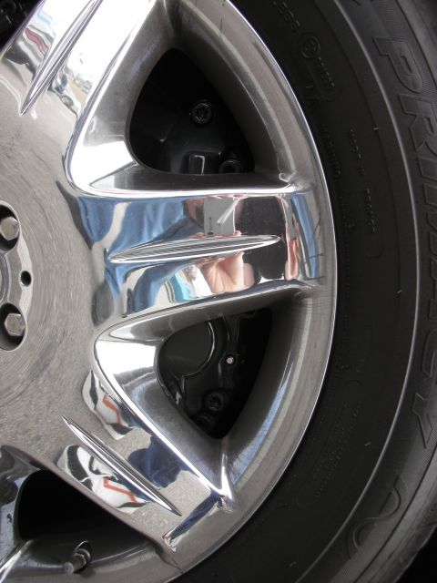 1998 Ford Crown Victoria - close-up of a polished chrome multi-spoke alloy wheel mounted with a tire.