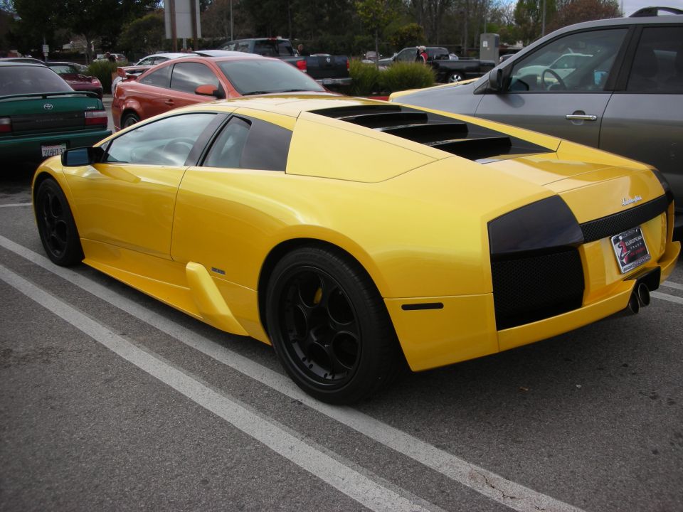 Yellow Lamborghini Murcielago, rear three-quarter view in parking lot