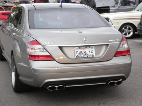 1998 Ford Crown Victoria - Rear three-quarter view of a silver Mercedes-Benz S65 AMG sedan with quad exhaust and a California license plate.