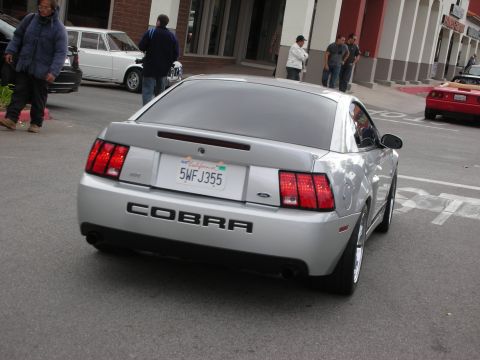 1998 Ford Crown Victoria - Rear view of a silver Ford Mustang SVT Cobra coupe with COBRA lettering and a California license plate.