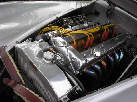 1998 Ford Crown Victoria - Engine bay of a classic Jaguar showing a polished twin-cam inline-six with dual carbs and an alloy radiator.